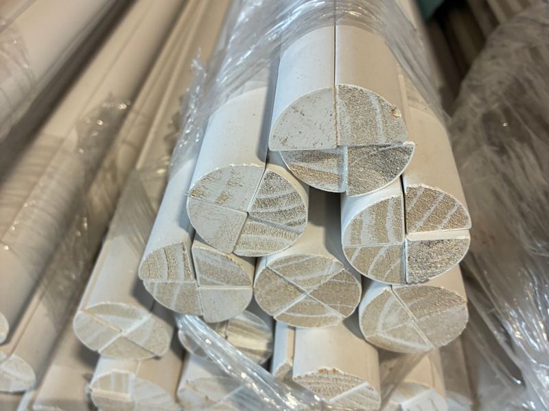 Bundles of primed quarter round molding